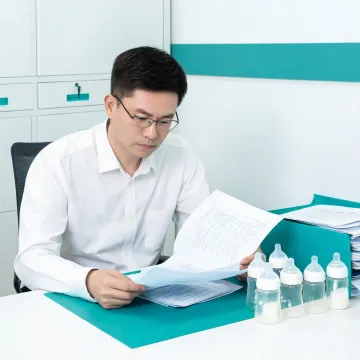 Product safety reviewer with baby bottle samples